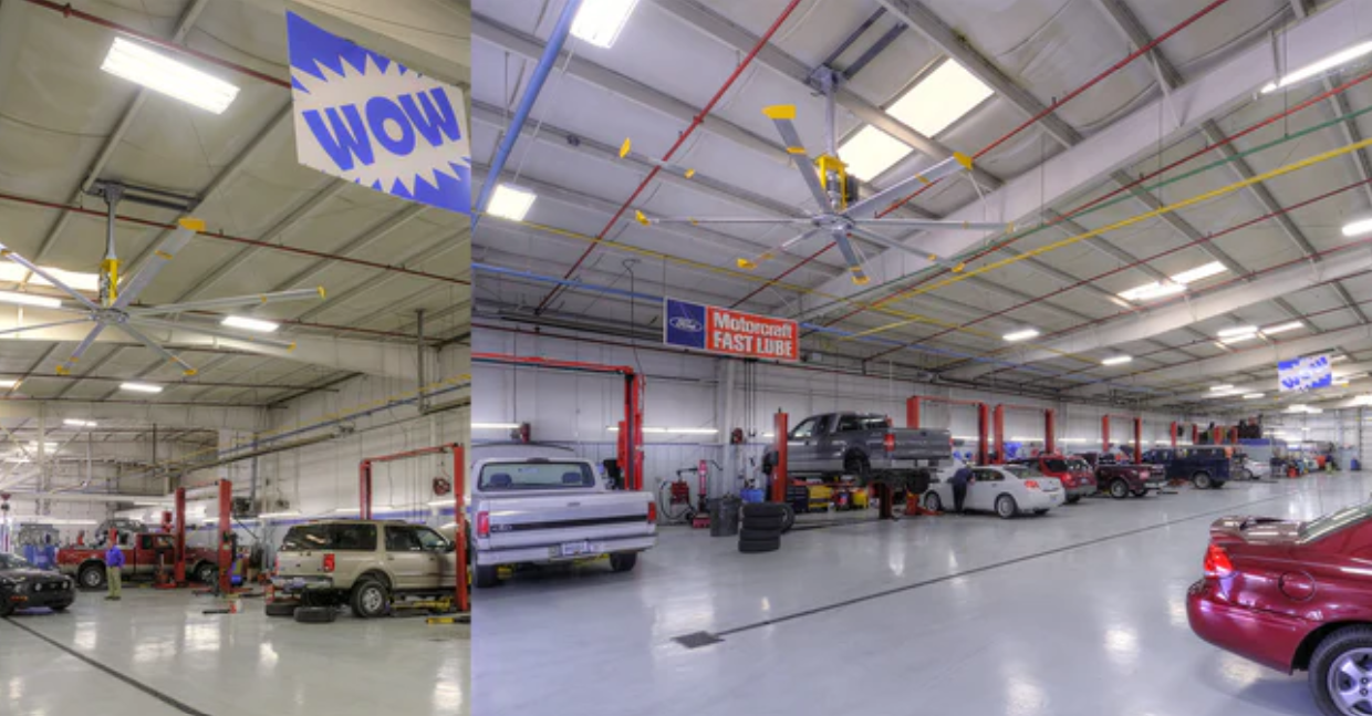 Interior of an auto shop with Big Ass Fans mounted on the ceiling.