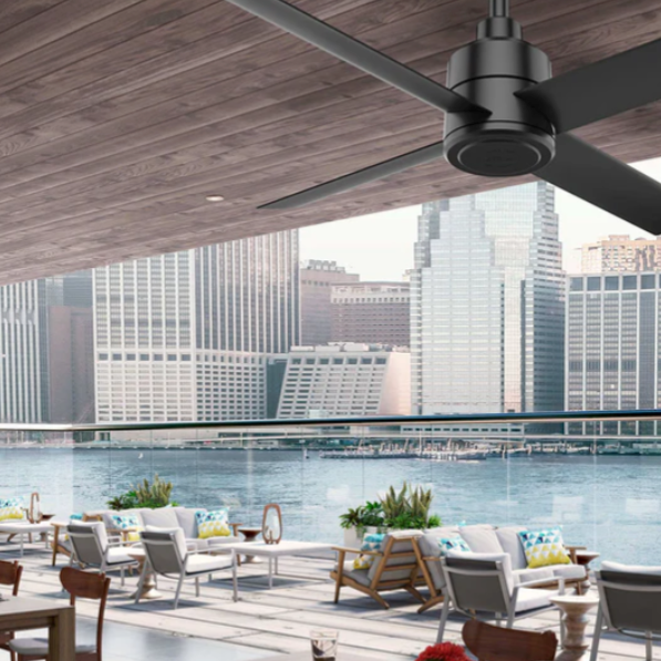 A stylish black ceiling fan on a city deck overlooking the water.